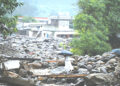 Locals walk across a makeshift bamboo and wooden crossing